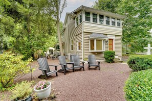 A two-story building with a gravel patio, surrounded by greenery. - Upper Black Eddy Home w/ Delaware River Access! (Upper Black Eddy)