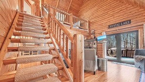 A wooden staircase with carpeted steps leading to a balcony. - The Hillside Hideaway at Crystal Lake - Gorgeous with Great Outdoor Deck and Spa! (Beulah)