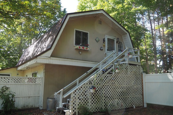 EXTERIOR: The outside of the home. The apartment consists of the entire second floor.