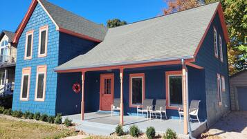 A two-story house with a blue exterior and a grey roof.