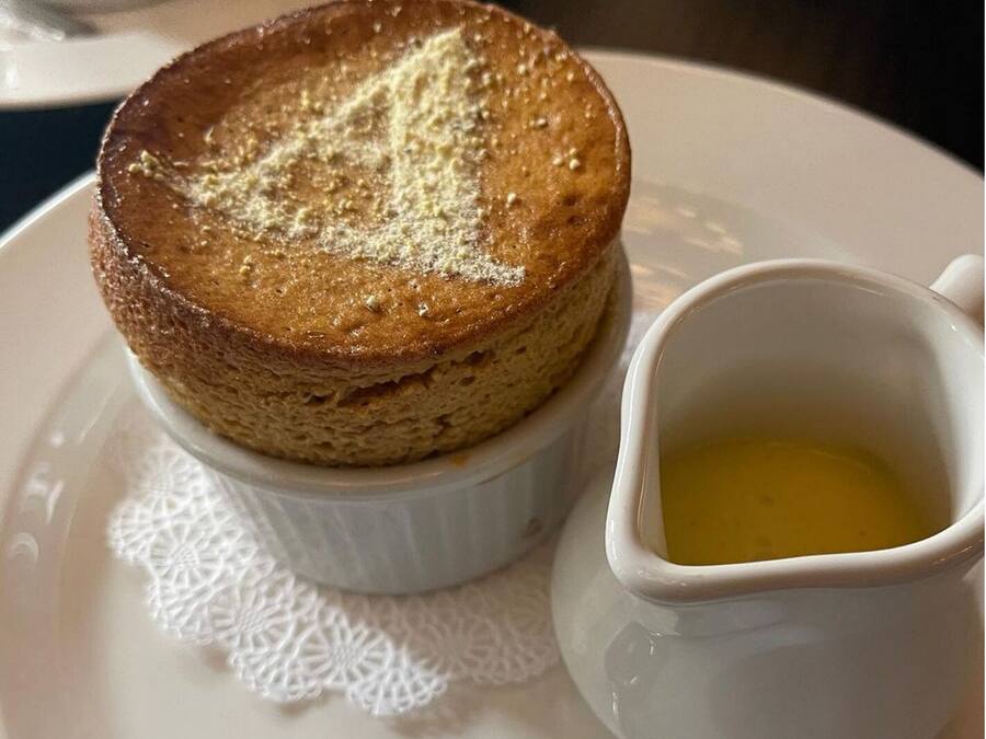 Dessert auf einem Teller mit einer kleinen Schale Sirup.