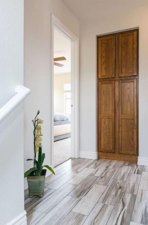 Enter a serene space with a comfortable bed and a beautiful view through the doorway.