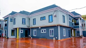 A two-story residential building with a flat roof and multiple windows. - Spacious 3 bedroom  Apartment,  All room ensuite , Ipaja Lagos (Lagos)