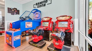 A gaming zone with arcade machines, a basketball hoop, and a blue gaming machine labeled "HOOPS EX". - 2021 Lelani Circle (Davenport)