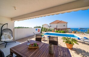A balcony with a pool, outdoor furniture, and a view of the sea. - Gorgeous apartment in Cavtat (Cavtat)