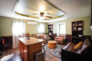 Deluxe House, 1 Bedroom | Living area | 55-inch Smart TV with digital channels, books