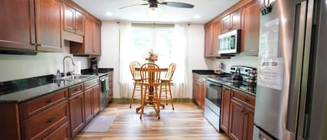 Deluxe Penthouse | Private kitchen | Full-size fridge, microwave, oven, stovetop