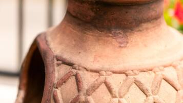 A close-up of a terracotta pot with a textured pattern.