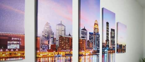 A series of cityscape paintings on a wall.