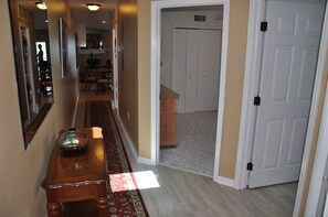 Enter a serene space with a comfortable bench, patterned rug, and stylish dresser.