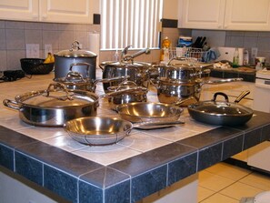 Kitchen equipped with a variety of cookware and kitchenware.