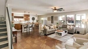 A spacious living area with a sofa set, a coffee table, and a dining area with chairs. - Stunning Heated Pool +Game Room +Great Location
 (Gilbert)