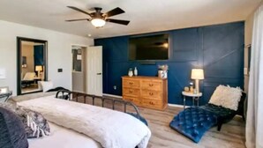 A bedroom with a bed, a dresser, a mirror, a ceiling fan, and a window. - Stunning Heated Pool +Game Room +Great Location
 (Gilbert)