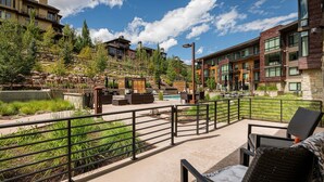 A resort patio with outdoor seating, a pool, and a view of the surrounding buildings. - Unbeatable Location! Near Hiking Trails! Park City Lift 301 Ski-in/Ski-out (Park City)