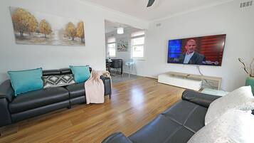 Family House | Living area | 65-inch TV with cable channels