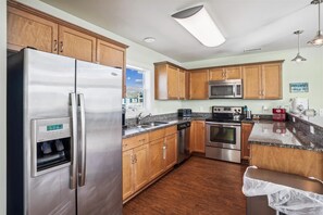 Enjoy cooking in this well-equipped kitchen with a refrigerator, microwave, and oven.