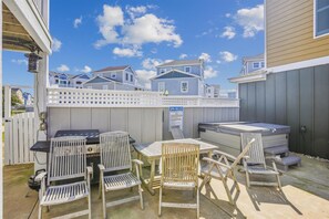 Relax in the backyard with a barbecue grill, hot tub, and comfortable seating areas.