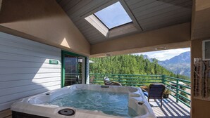A hot tub on a deck with a view of mountains. - Eolus Ski-in/Ski-Out Condo w/ private hot tub/deck and Awesome Mountain Views (Durango)