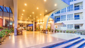 A spacious lobby with a grand staircase, potted plants, and a modern architectural design. - Eastiny Resort & Spa (Pattaya)