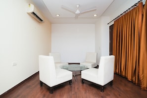 Relax in this stylish room with a central table and two comfortable armchairs.