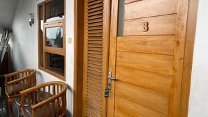 A wooden door with a letter 'B' and a window with blinds. - Villa Buana Graha Syariah (Lembang)
