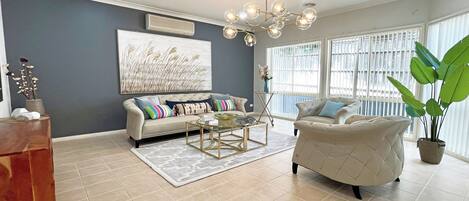 Grand House | Living room | 65-inch TV with cable channels