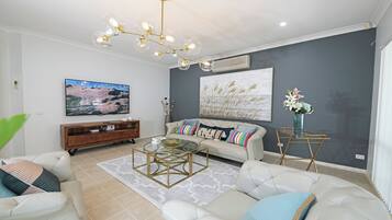 Grand House | Living room | 65-inch TV with cable channels