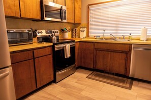 Enjoy cooking in this well-equipped kitchen with a microwave, toaster, oven, and dishwasher.