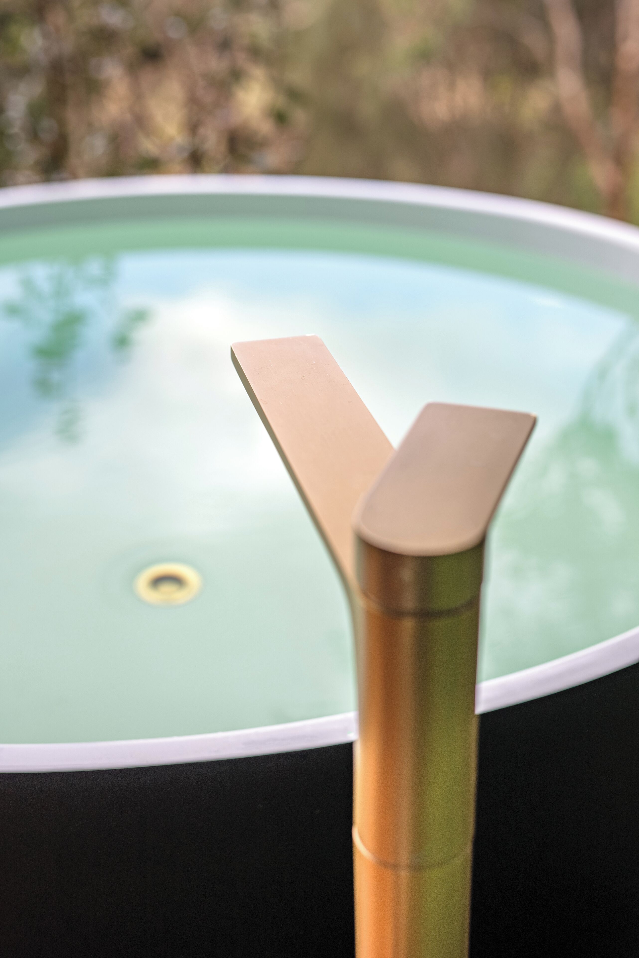 A close-up of a metallic object with a curved design, possibly part of a piece of furniture or equipment.