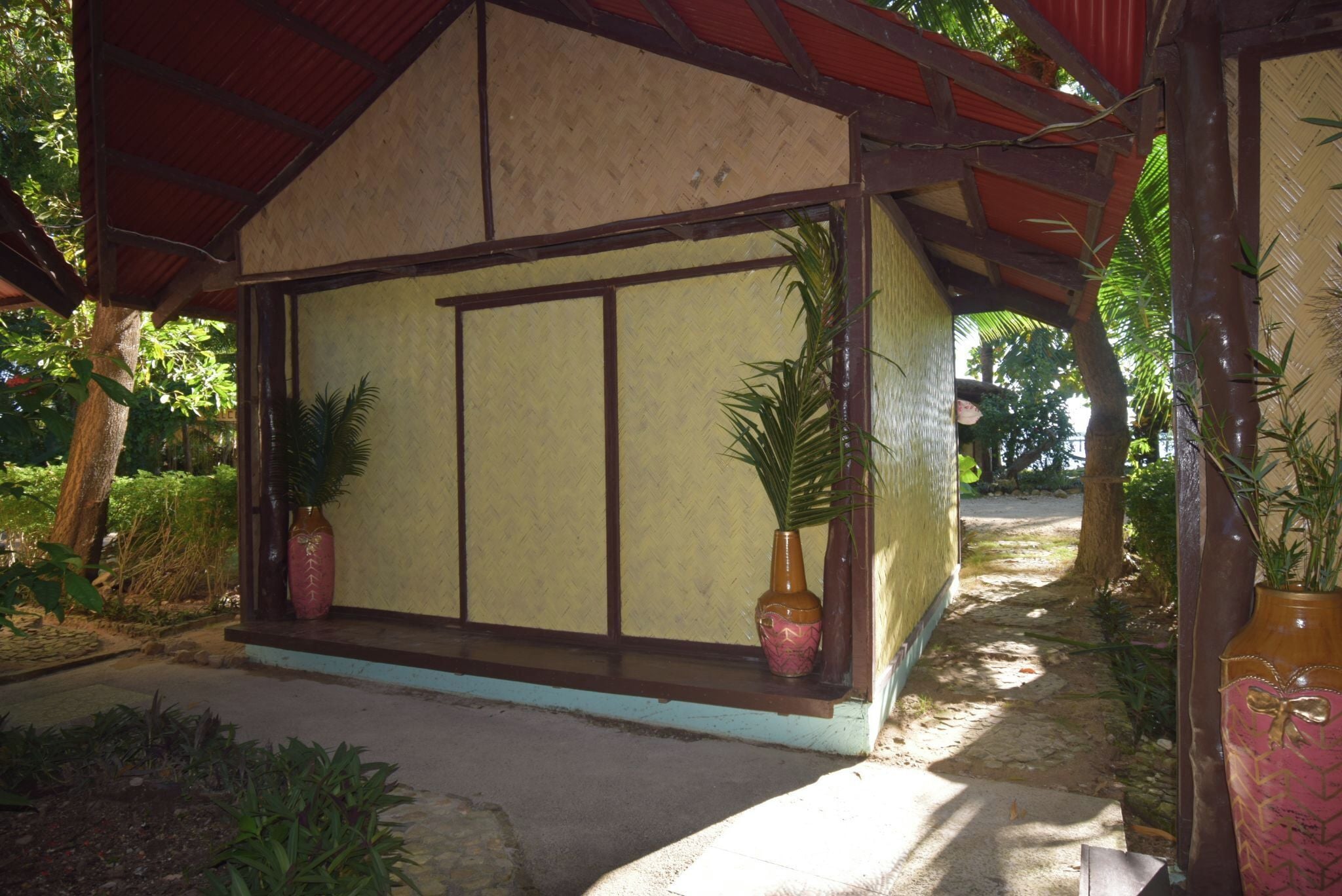 A small, single-story building with a tiled roof and a large window.