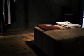 Relax in a warm and inviting space with a comfortable ottoman and plush amenities.