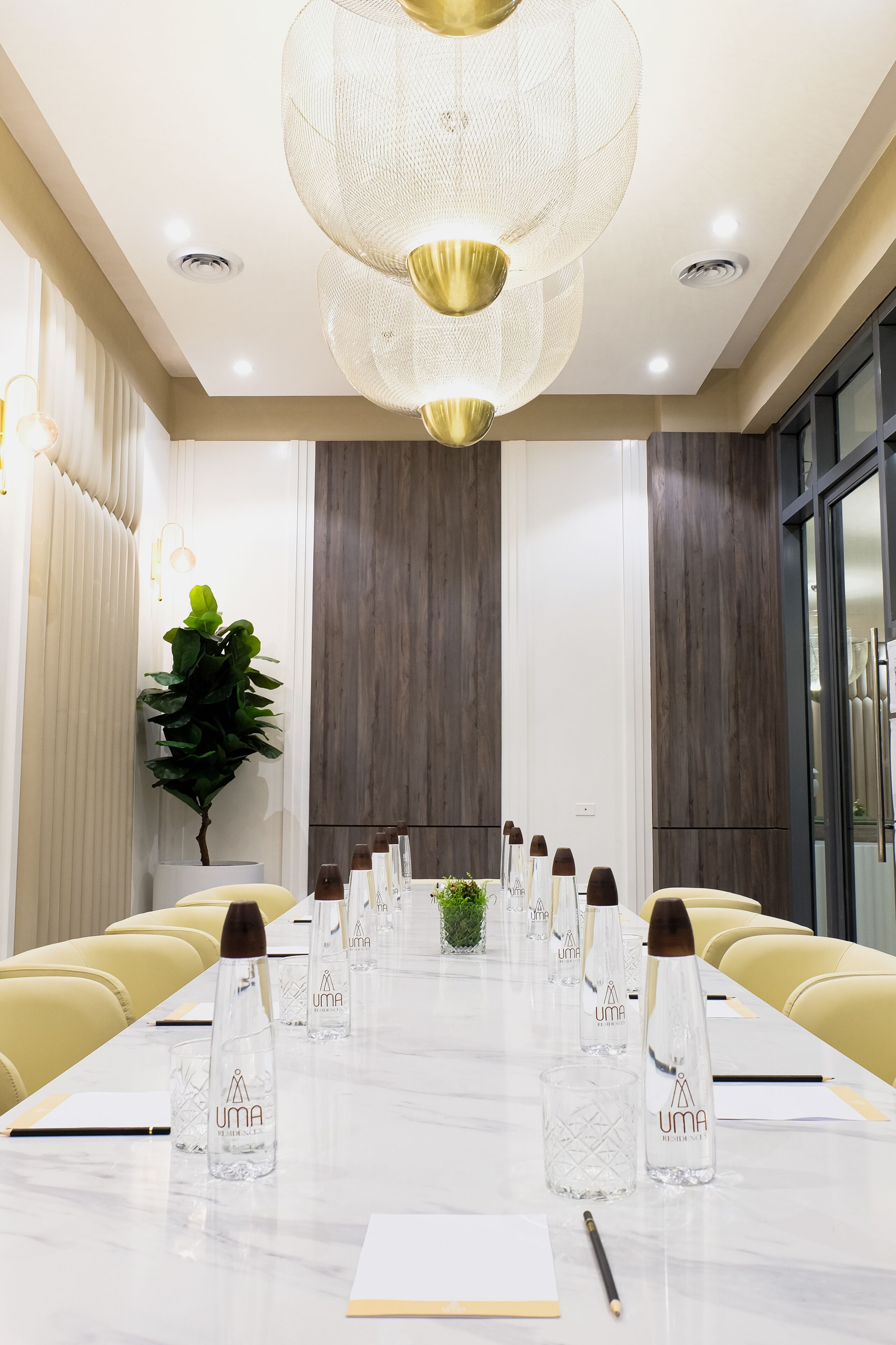 A conference room with a long table, chairs, and a chandelier.
