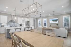 A modern kitchen with a central island, white cabinetry, and pendant lighting. - 5BR Luxury 3-Story Home w/ Private Pool! ~ Sealestial at Seacrest Beach, 30A (Inlet Beach)