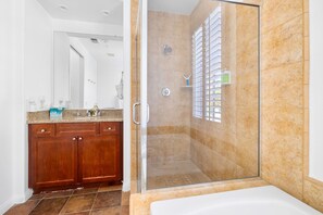 Bathtub, hair dryer, towels, shampoo