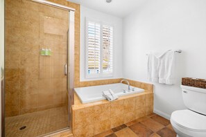 Bathtub, hair dryer, towels, shampoo