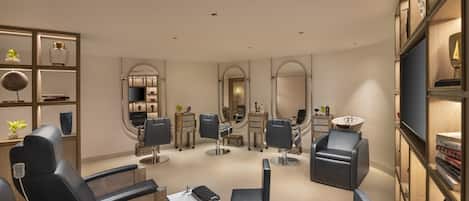 A modern salon with multiple hairdressing stations, each equipped with a chair, mirror, and sink.