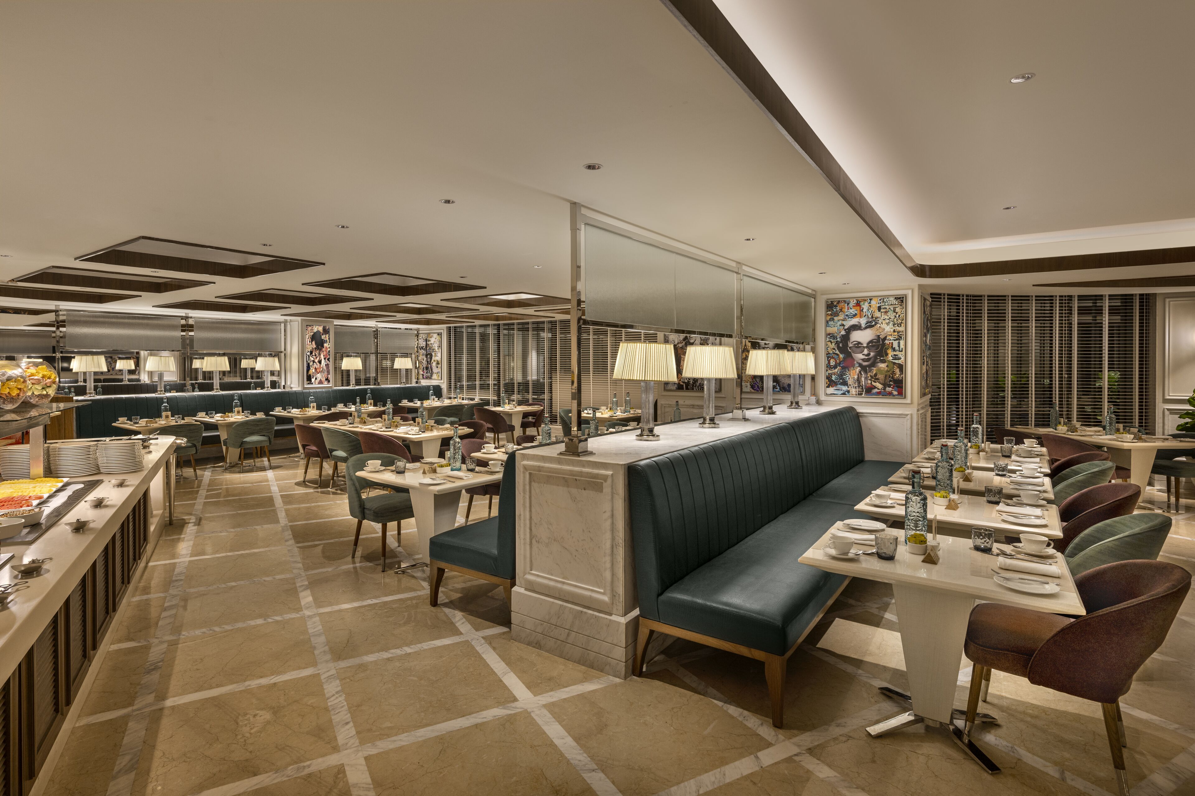 A modern dining area with a long counter, multiple seating options, and a central bar area.