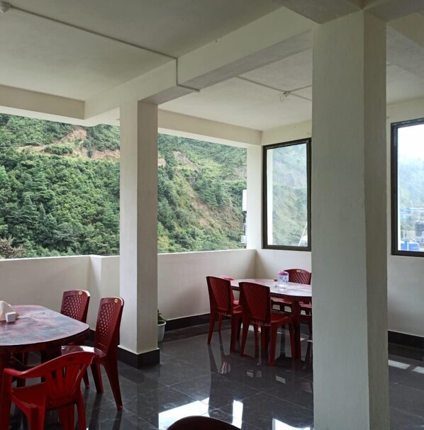 A room with a balcony overlooking a mountainous landscape. - Wangdi's Homestay (West Kameng)