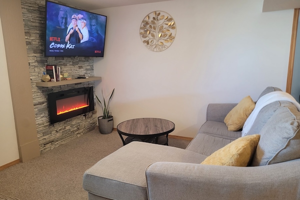 Living room with electric fireplace and 55" Samsung tv