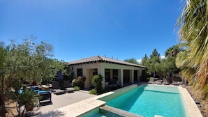 A pool area with a house, lounge chairs, and a hot tub. - Summer Early Late Access Private Pool Spa (Indio)