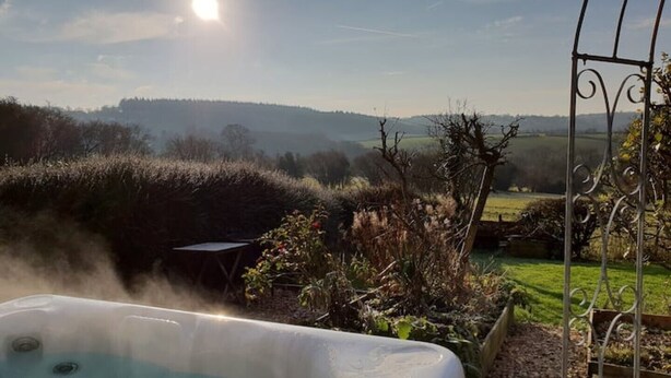 A hot tub with a view of a rural landscape, including fields and hills. - The Stables w/Hot tub, amazing views, English Bicknor Forest of Dean (Coleford)