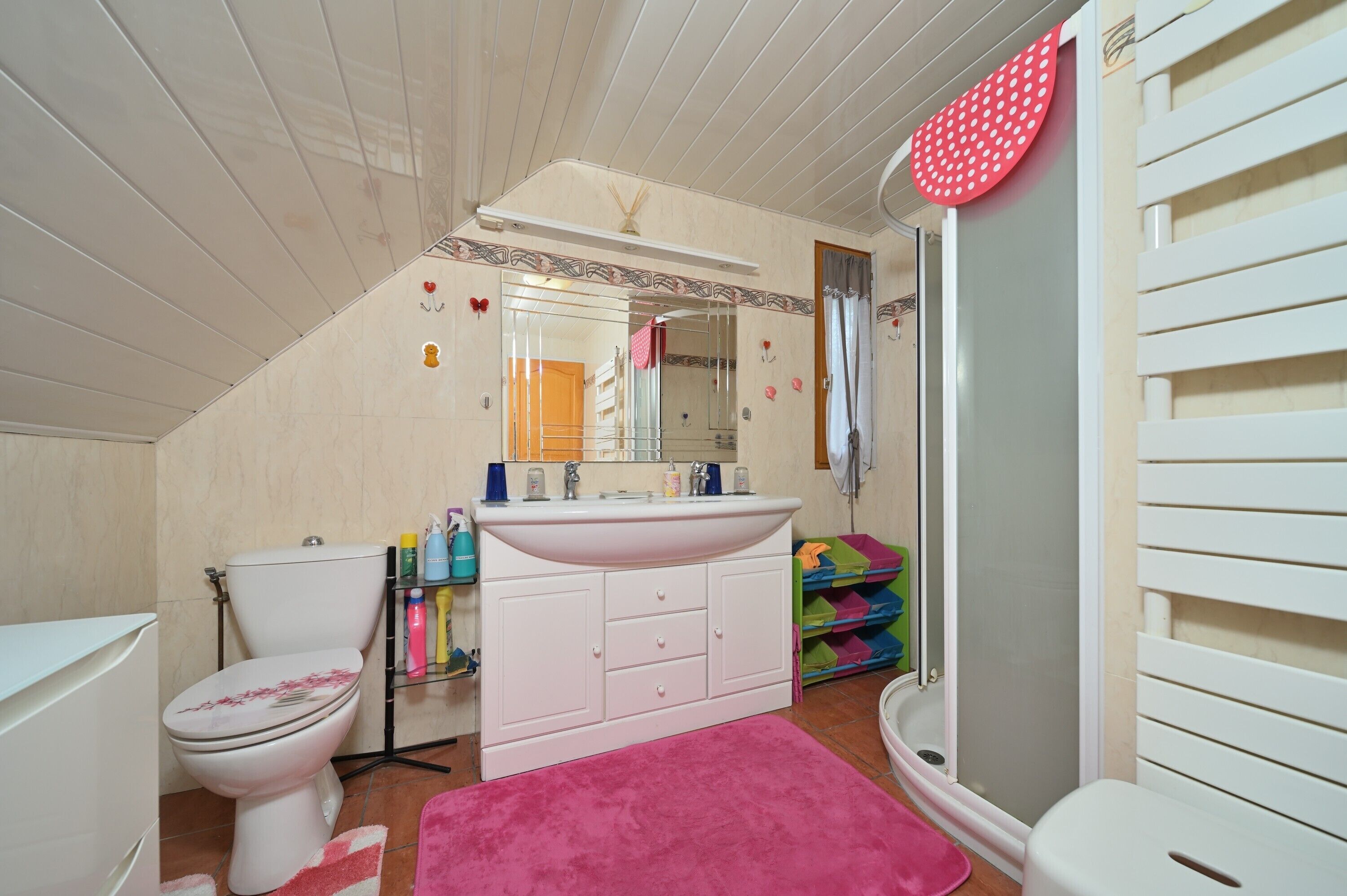 Une salle de bain avec des toilettes, un lavabo et une douche.