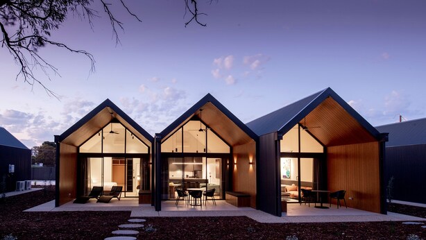 A modern house with a symmetrical design, featuring large glass windows and wooden accents. - Par Five Shacks (Berri)
