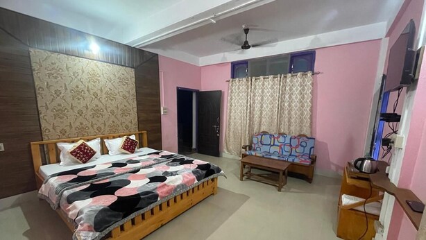 A bedroom with a wooden bed, a ceiling fan, a desk with a chair, and a window with curtains. - Eight Lucky Homestay (West Kameng)