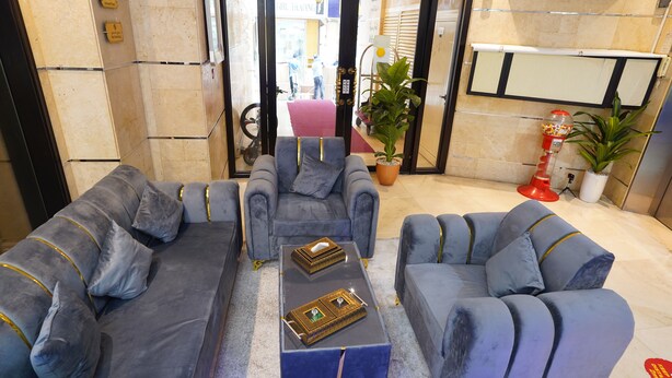 A lobby with two grey sofas, a coffee table, and a potted plant. - Cube Hotel Dubai (Dubai)