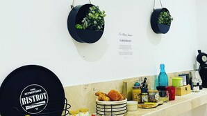 A kitchen counter with a black plate labeled "MENU AUTHENTIQUE BISTROT" and a wall-mounted sign with text.