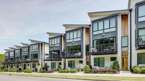 A row of modern multi-story residential buildings with balconies and large windows. - Modern Townhome w/ Game Room + 10min to Downtown! (Nashville)