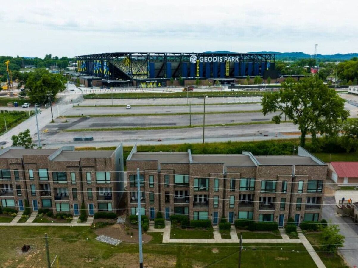 A multi-story building with a modern architectural design, featuring a mix of brick and glass facades.