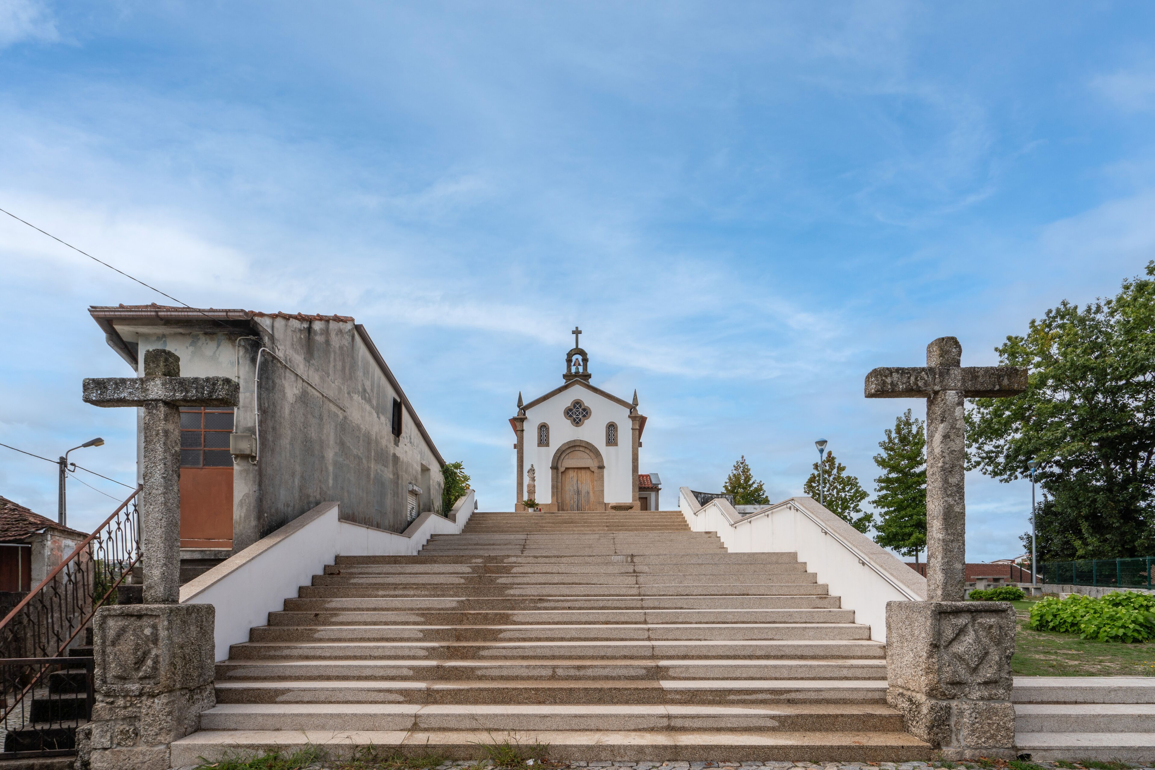 A church with a central dome, a bell tower, and a cross at the top.