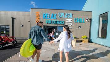 A building with a sign reading "RELAY SPLASH POOL ENTRANCE" and "CHILL".